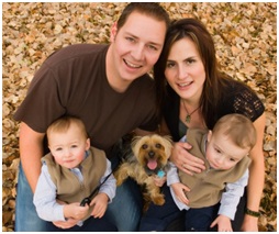 a picture of a family of 4 with there pet dog